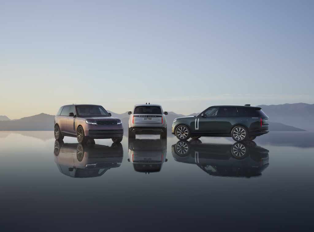Three 2027 Range Rover Electric models parked on a reflective salt flat