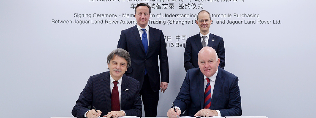 Prime Minister David Cameron and British Ambassador to China Sebastian Wood witness the signing of an MoU by Jaguar