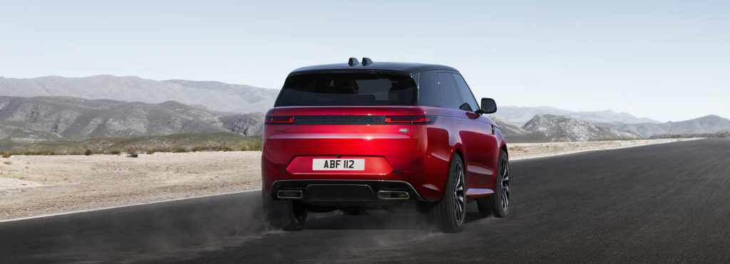 Red Range Rover Sport driving on an open road