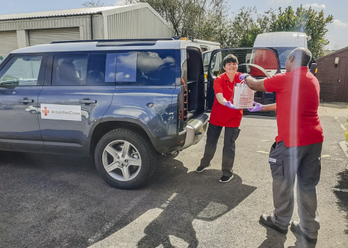 British Red Cross Volunteers from Bristol use Land Rover Defenders to deliver support packages for those in need