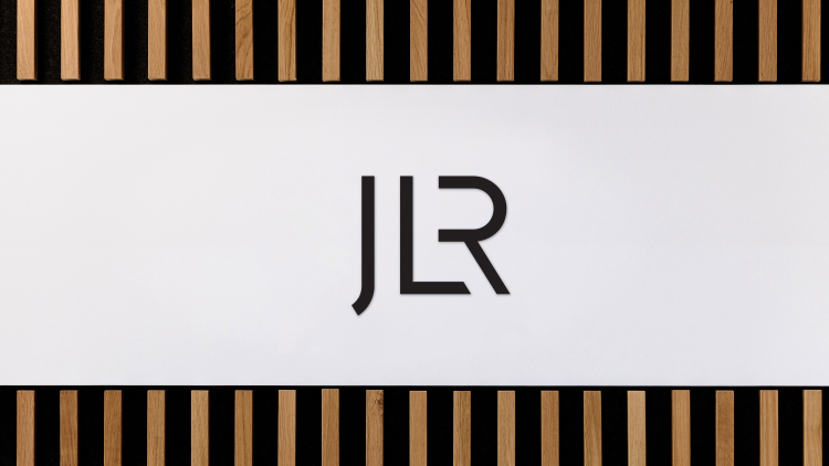 Image shows the JLR  ( Jaguar Land Rover ) logo on JLR Building in 2025. UK Luxury Automotive manufacturer makes Range Rover, Defender, Discovery and Jaguar brands.